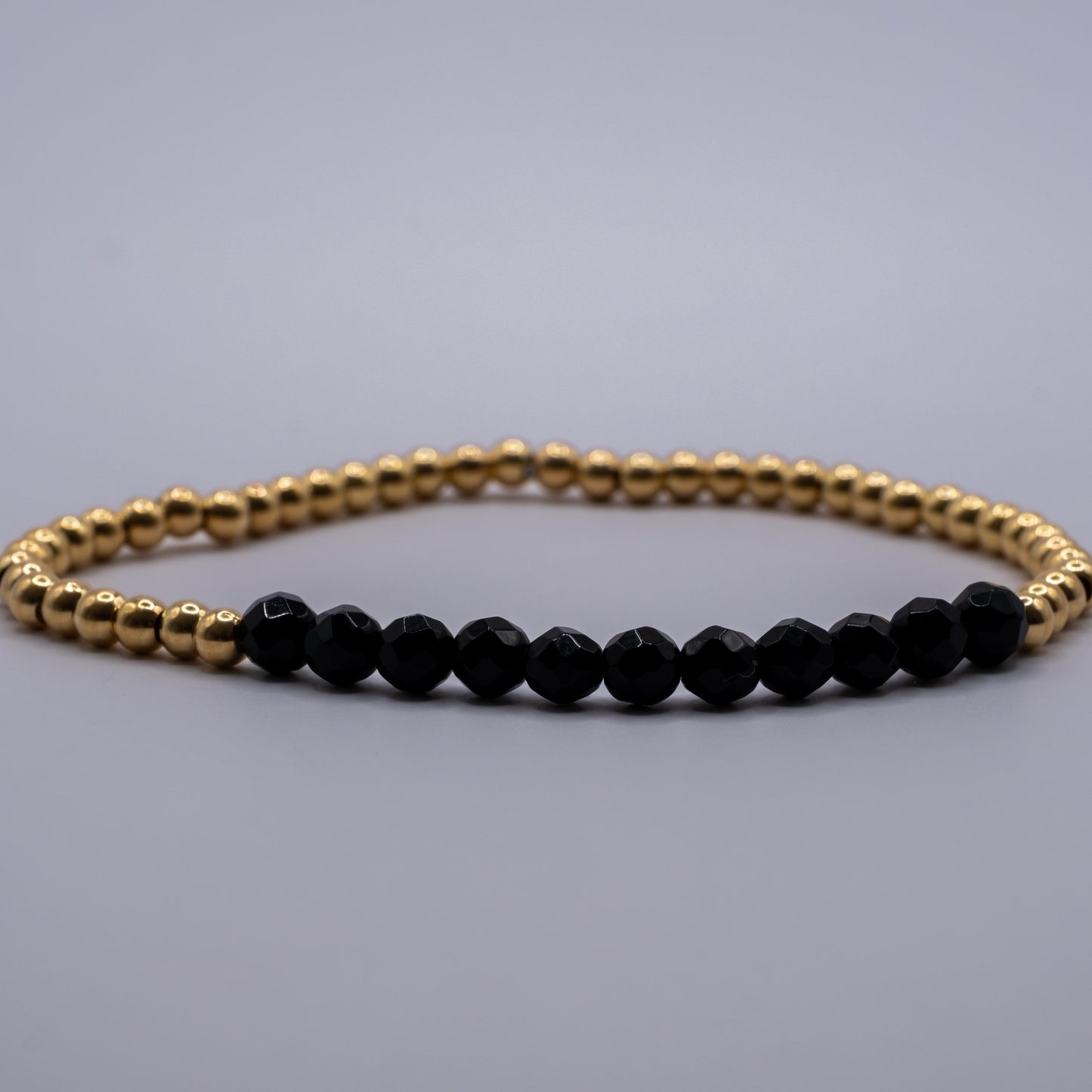 Armband Onyx - facettiert golden