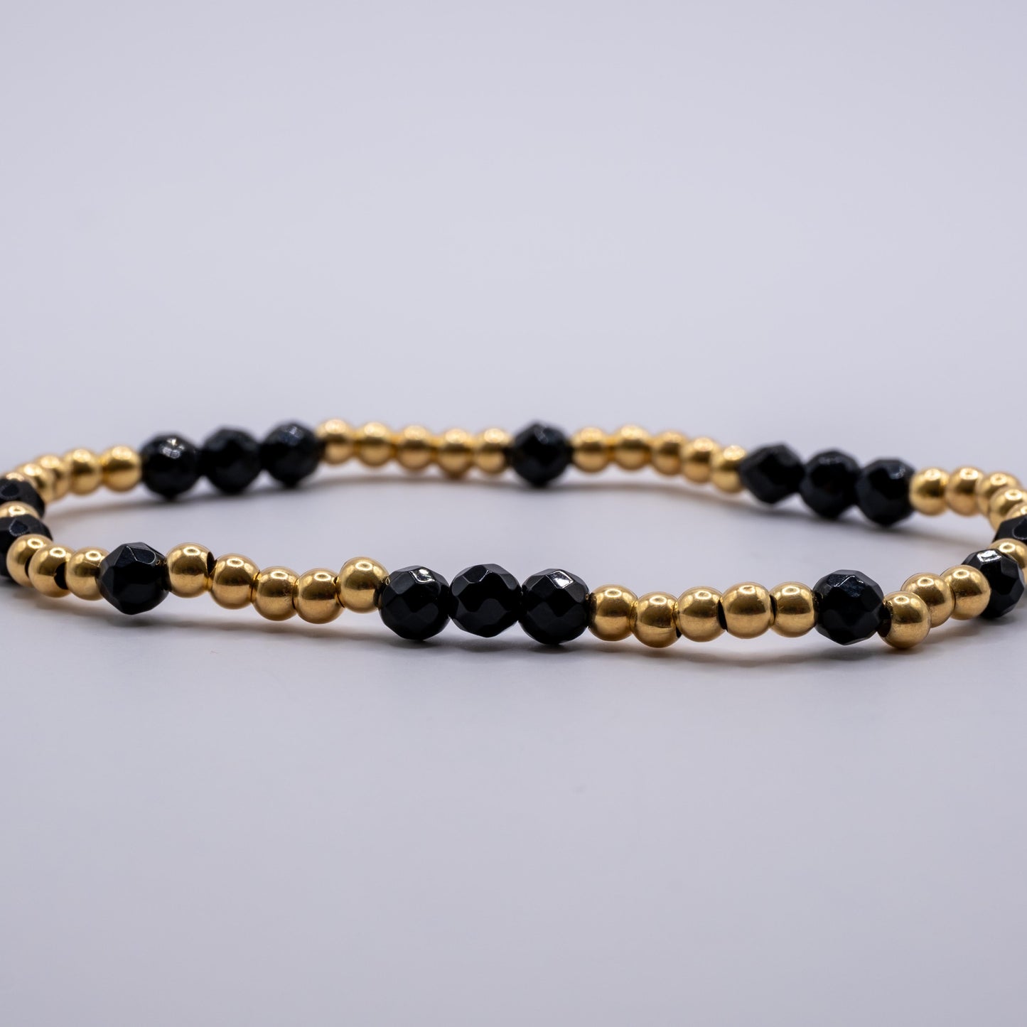 Armband Onyx - facettiert gold